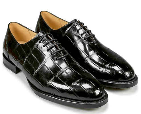 Black patent leather oxford dress shoes with a glossy finish and stitched grid pattern.