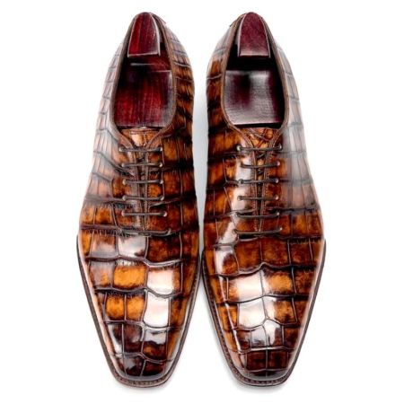 Pair of brown crocodile-embossed leather dress shoes, lace-up, viewed from above, formal footwear