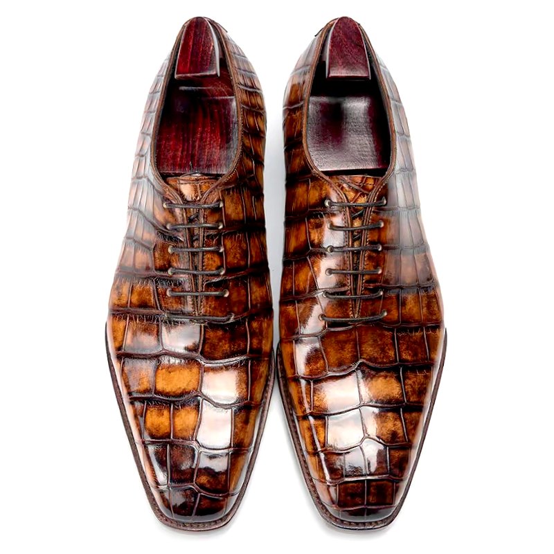 Pair of brown crocodile-embossed leather dress shoes, lace-up, viewed from above, formal footwear